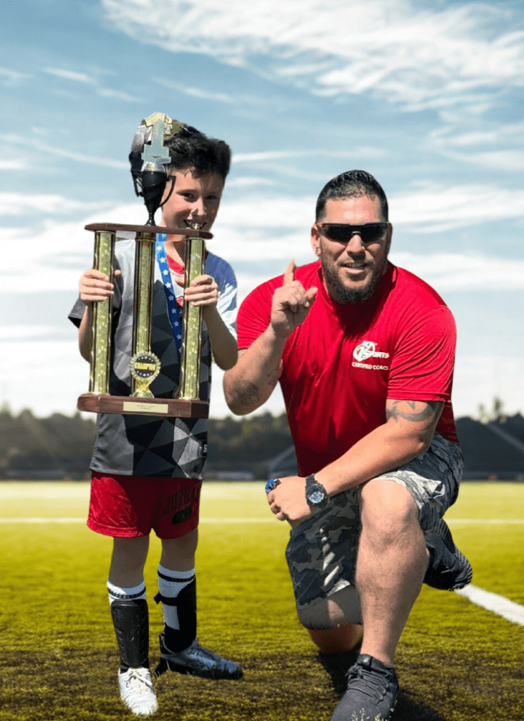 Codee coaching youth soccer with his son