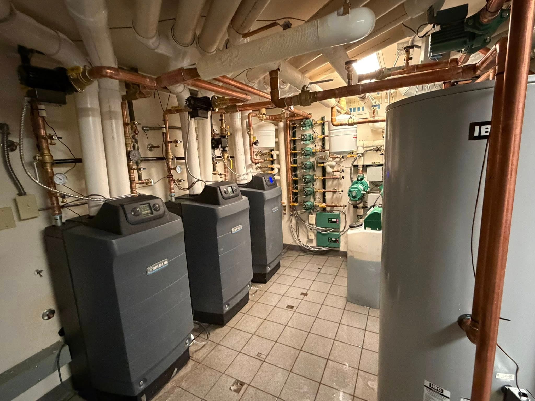 Multi-boiler mechanical room with copper near-boiler piping installed by Nathan Locke