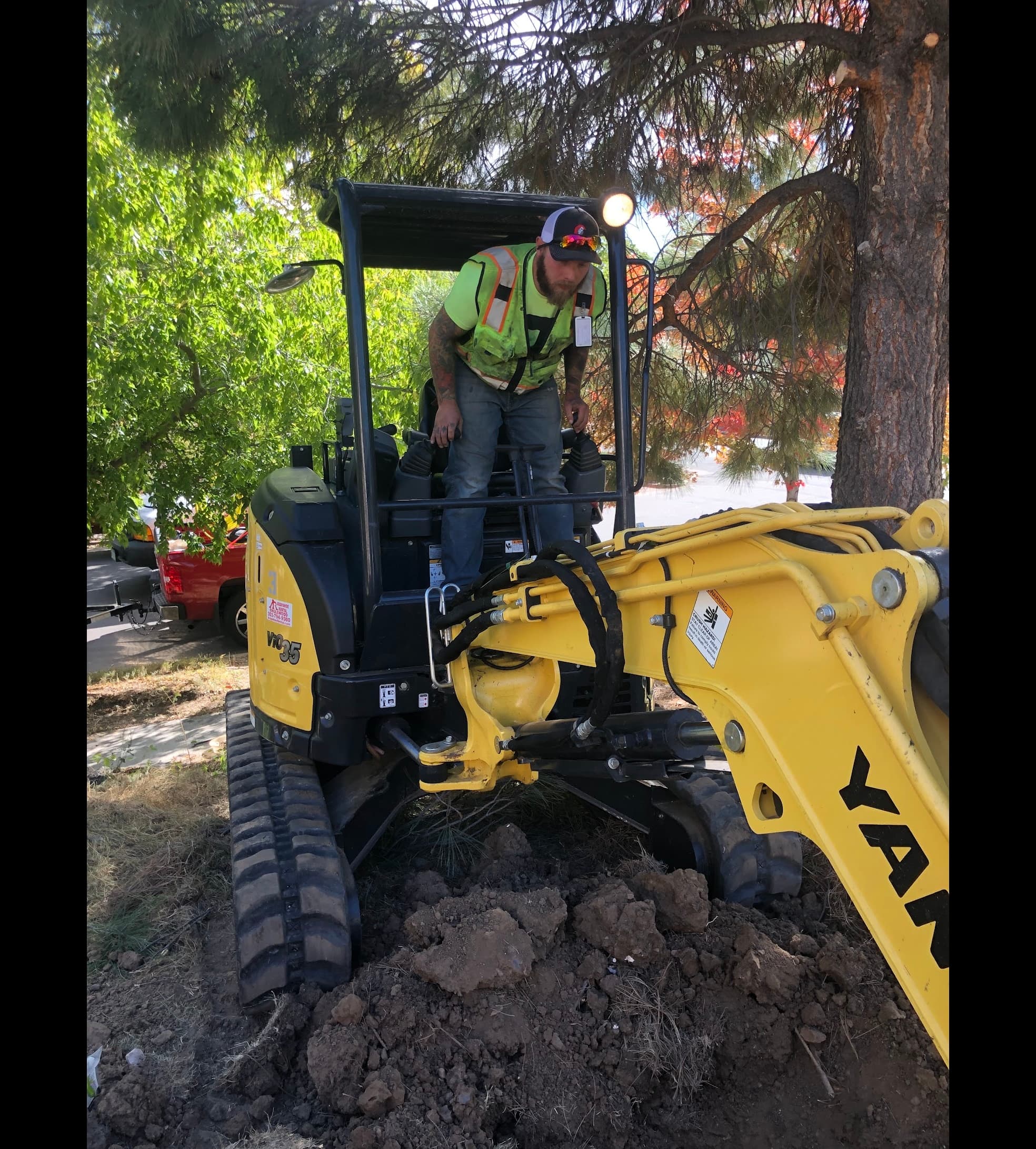 Nick Velasquez operating a mini-excavator for sewer mainline work