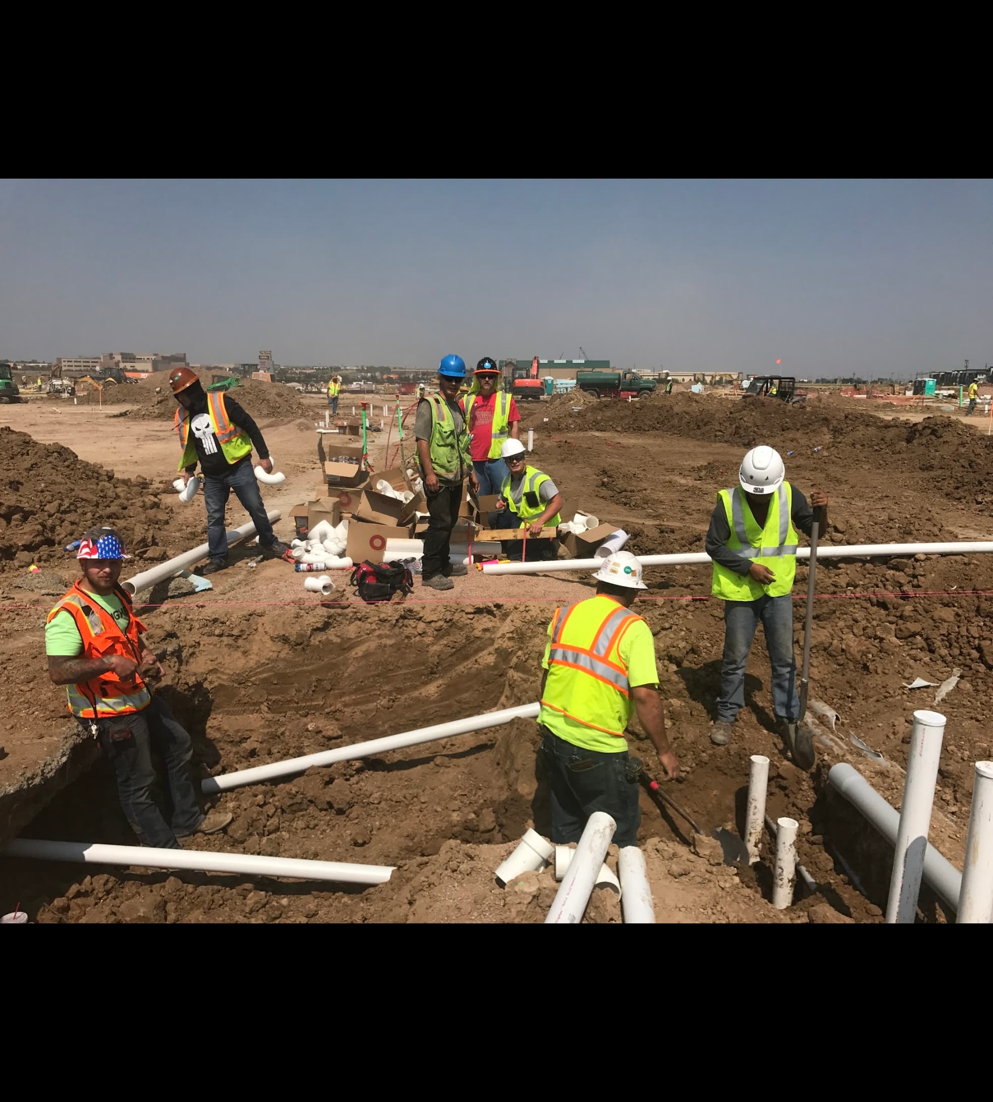 Underground plumbing crew installing DWV on a large multifamily jobsite